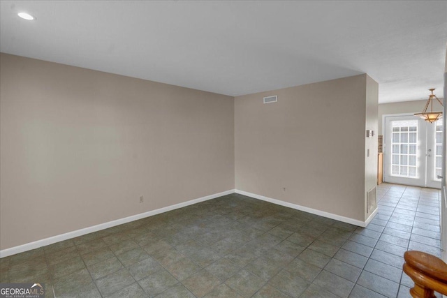 unfurnished room featuring an inviting chandelier, recessed lighting, visible vents, and baseboards