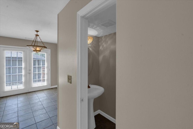 bathroom with tile patterned floors, french doors, baseboards, and visible vents