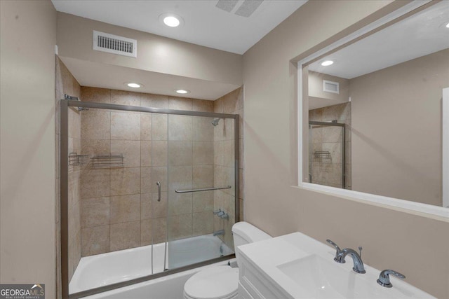 bathroom featuring visible vents, toilet, a sink, recessed lighting, and bath / shower combo with glass door