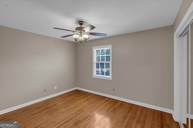 unfurnished bedroom featuring a closet, a ceiling fan, baseboards, and light wood finished floors