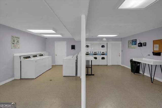 basement featuring tile patterned floors, baseboards, stacked washer and dryer, and washer and dryer