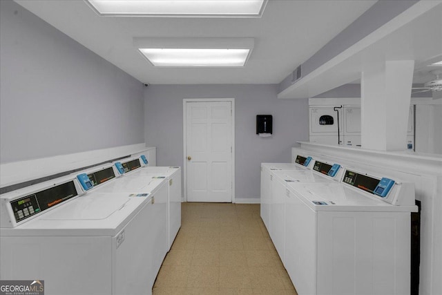 common laundry area featuring visible vents, light floors, and washer and clothes dryer