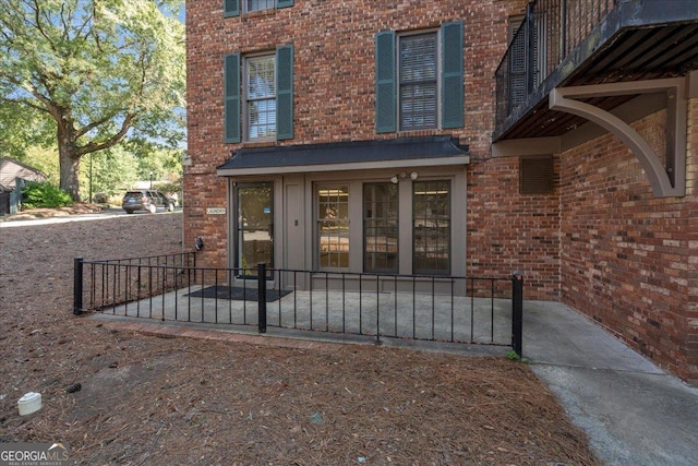 entrance to property featuring brick siding