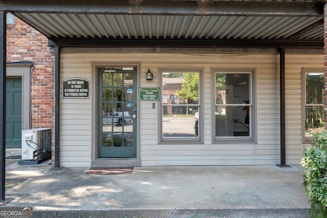 view of exterior entry with central air condition unit