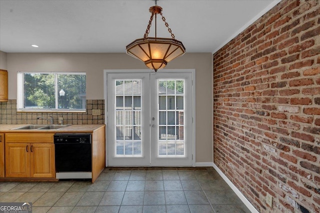 kitchen featuring a sink, french doors, dishwasher, and brick wall