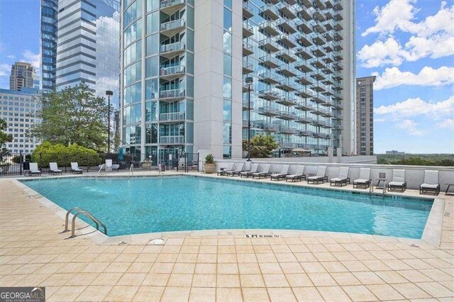 3324 Peachtree Rd NE Unit 1115, Atlanta, GA 30326 - community pool with a patio area, a city view, and fence