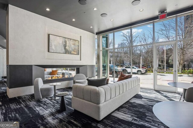 3324 Peachtree Rd NE Unit 1115, Atlanta, GA 30326 - living area with a multi sided fireplace, plenty of natural light, and floor to ceiling windows