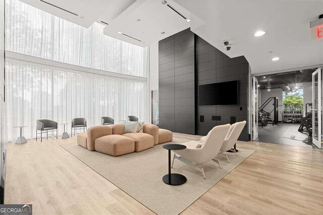 3324 Peachtree Rd NE Unit 1115, Atlanta, GA 30326 - living area with a wall of windows, wood finished floors, and recessed lighting