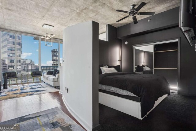 3324 Peachtree Rd NE Unit 1115, Atlanta, GA 30326 - bedroom featuring wood finished floors, baseboards, floor to ceiling windows, a city view, and access to outside