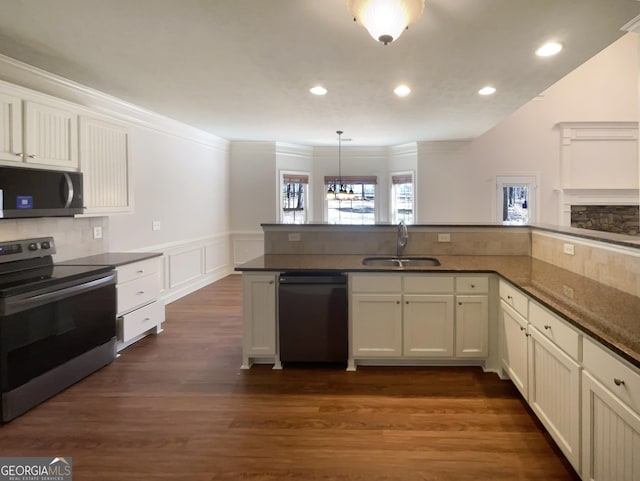 kitchen with stainless steel electric range, dark wood-style flooring, a sink, wainscoting, and dishwasher