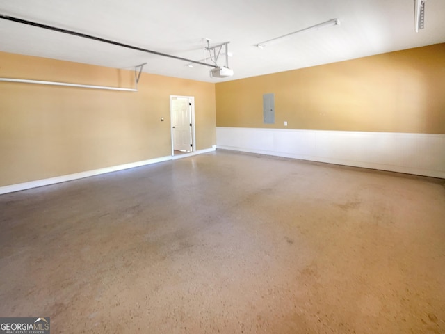 garage with electric panel and a garage door opener