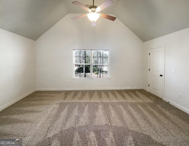 carpeted empty room with baseboards, lofted ceiling, and ceiling fan