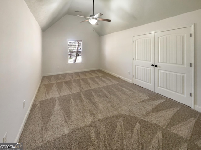 unfurnished bedroom with visible vents, carpet flooring, baseboards, ceiling fan, and vaulted ceiling