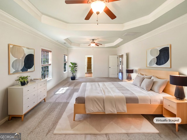 bedroom with light colored carpet, crown molding, a tray ceiling, and ceiling fan