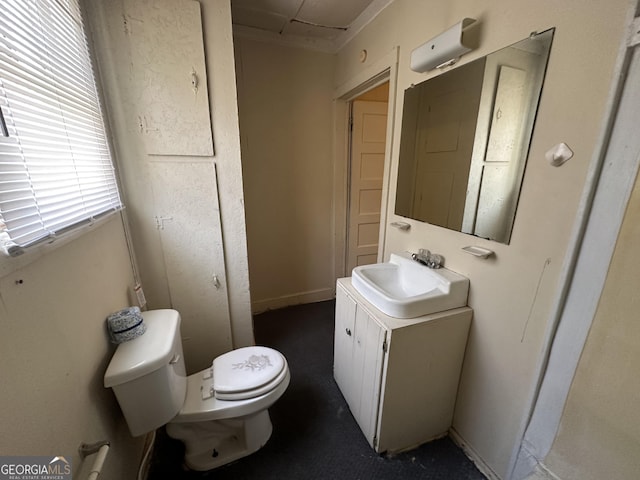 half bathroom with toilet and vanity