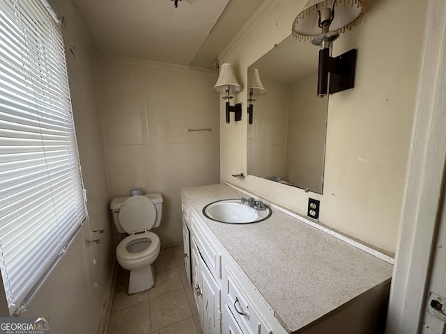 bathroom featuring toilet, vanity, and tile patterned flooring