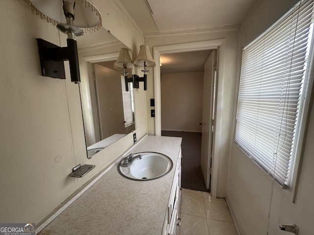 bathroom with vanity, tile patterned floors, and baseboards