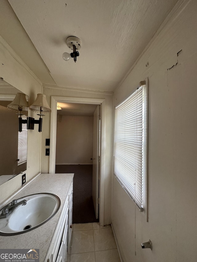 bathroom with tile patterned flooring and vanity