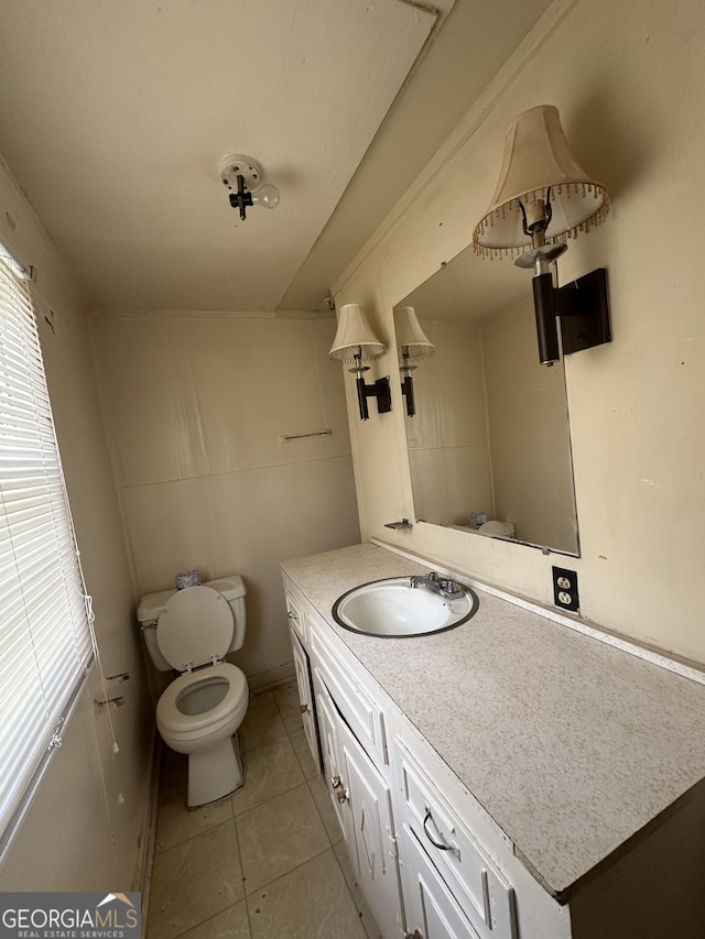 bathroom with vanity, tile patterned floors, and toilet