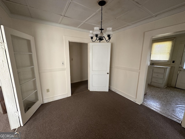 unfurnished dining area featuring an inviting chandelier and dark carpet