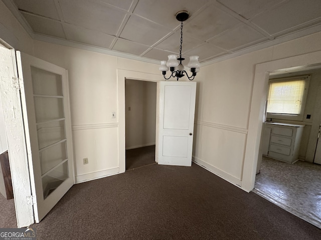 unfurnished dining area featuring dark carpet and an inviting chandelier