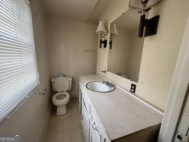 bathroom featuring toilet, vanity, and tile patterned flooring