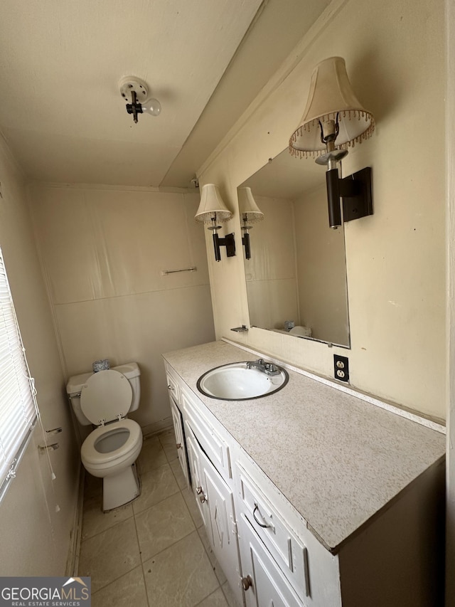 bathroom featuring vanity, tile patterned floors, and toilet