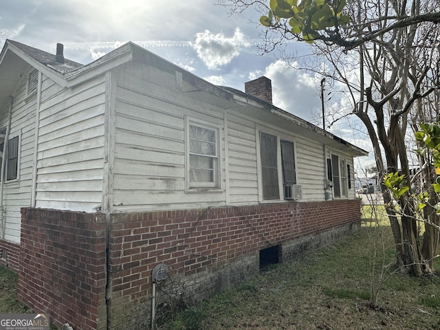 view of side of property featuring a chimney