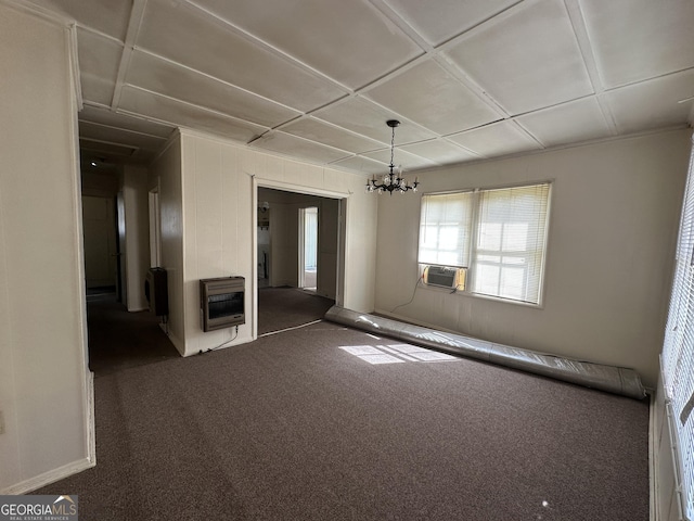 empty room with heating unit, cooling unit, coffered ceiling, a notable chandelier, and dark colored carpet