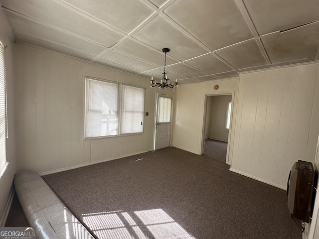 interior space with a chandelier and dark carpet