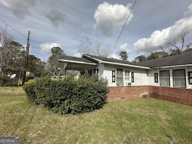 exterior space featuring crawl space, a yard, brick siding, and cooling unit