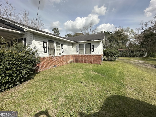 view of front of house featuring a front yard, cooling unit, brick siding, and crawl space