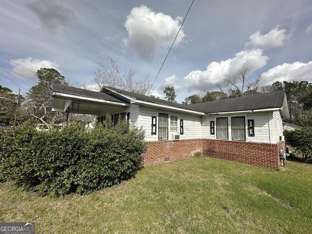 exterior space with brick siding, crawl space, and a front yard