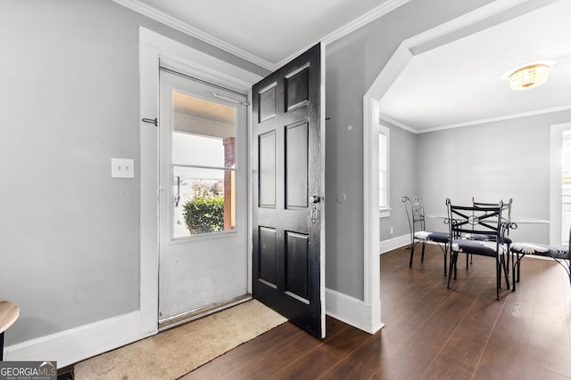 entryway featuring dark wood finished floors, baseboards, and ornamental molding