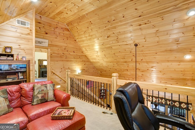 office space featuring wooden walls, visible vents, lofted ceiling, wooden ceiling, and carpet floors