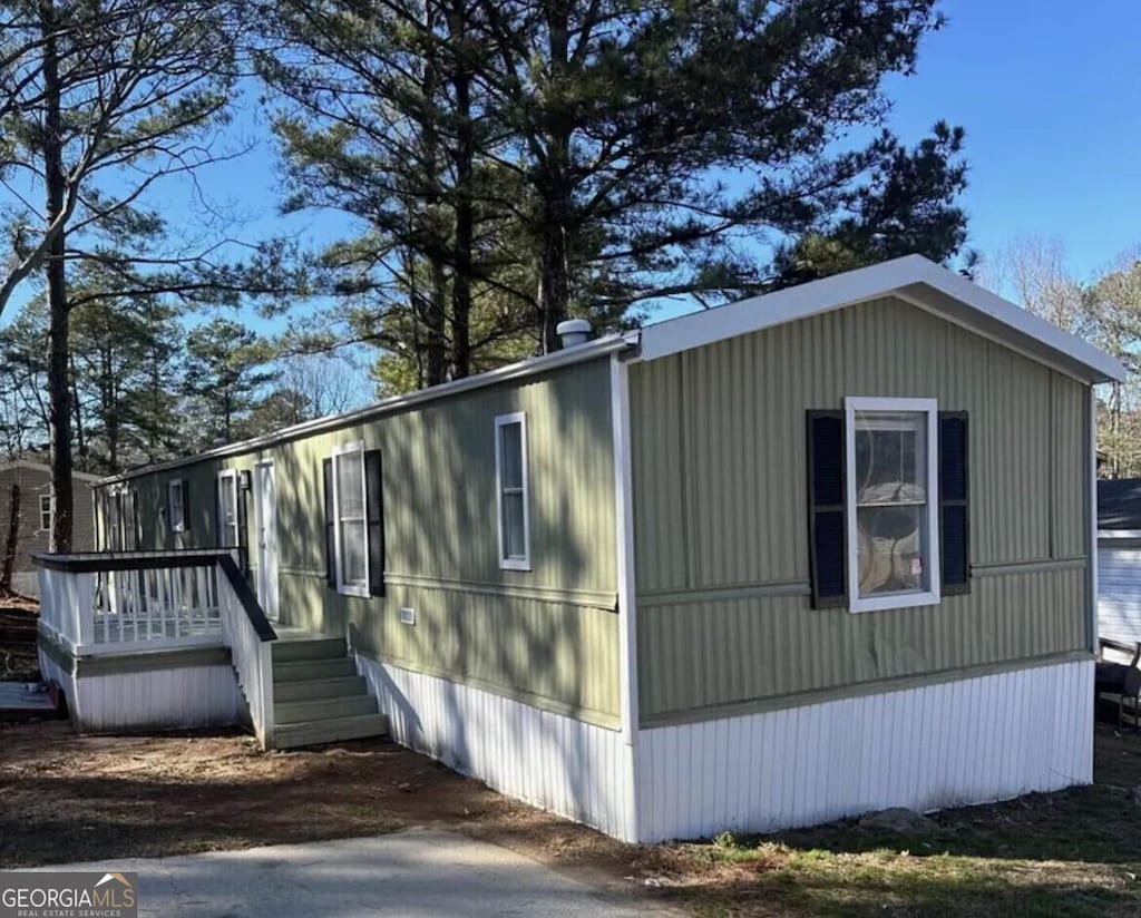 view of property exterior with a wooden deck