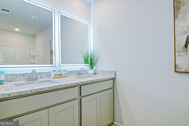 full bathroom with a sink, visible vents, and double vanity