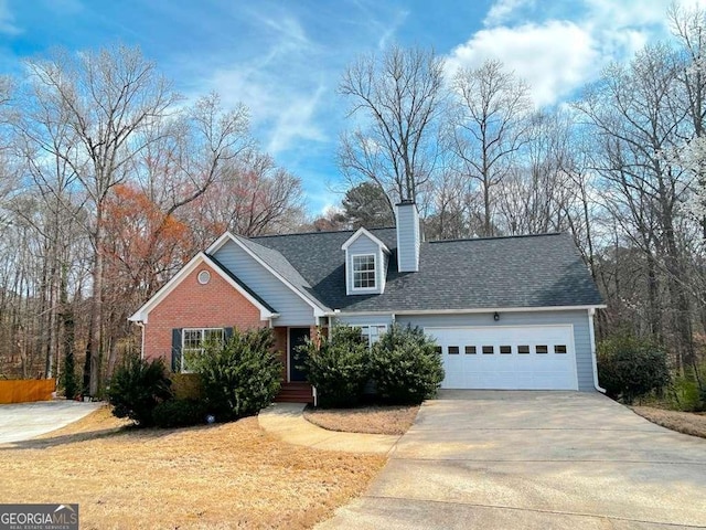 traditional home with a garage, brick siding, a chimney, and driveway