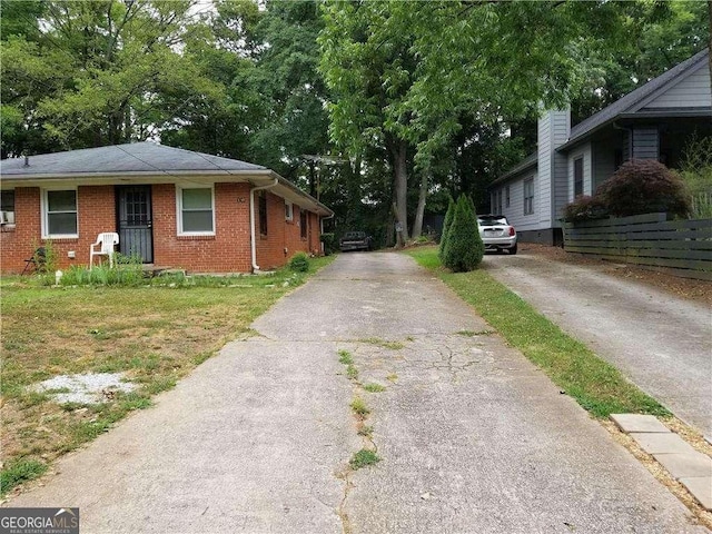 view of property exterior with fence and brick siding