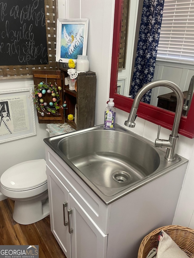 interior details with wood finished floors and a sink