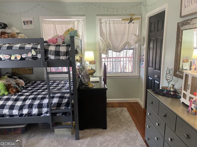 bedroom with dark wood-style floors and baseboards