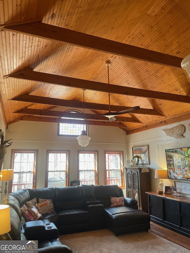 living area with lofted ceiling with beams, a healthy amount of sunlight, and a ceiling fan