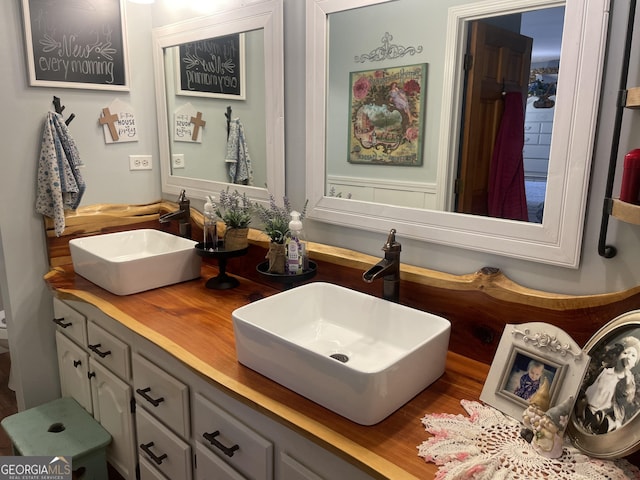 bathroom with double vanity and a sink