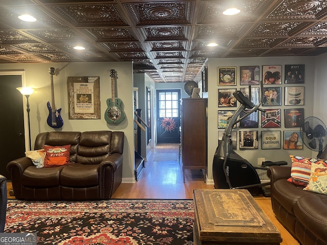 living area featuring wood finished floors and an ornate ceiling