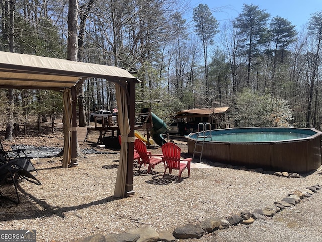 exterior space with a playground and an outdoor pool