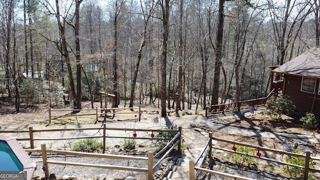 view of yard featuring a forest view