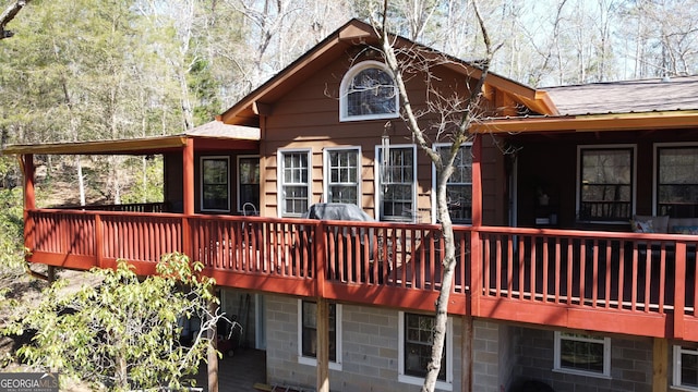 back of property featuring roof with shingles