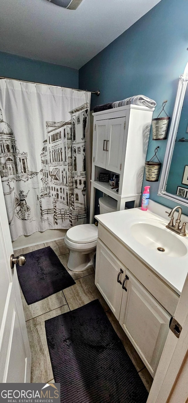 full bath featuring vanity and toilet