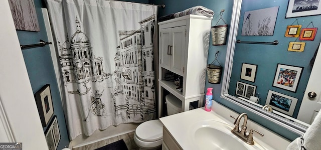 bathroom featuring toilet, shower / bath combo, and vanity