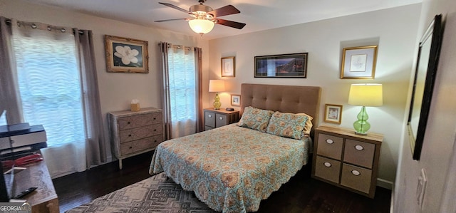 bedroom with ceiling fan and dark wood finished floors